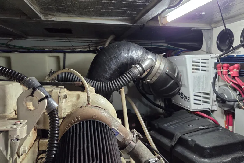 Slide: The Image of Engine room of 2000 Carver 450 Voyager Pilothouse with visible components and wiring. - 90