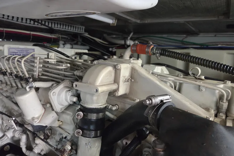 Slide: The Image of Engine compartment of a 2000 Carver 450 Voyager Pilothouse, showcasing detailed mechanical components. - 91