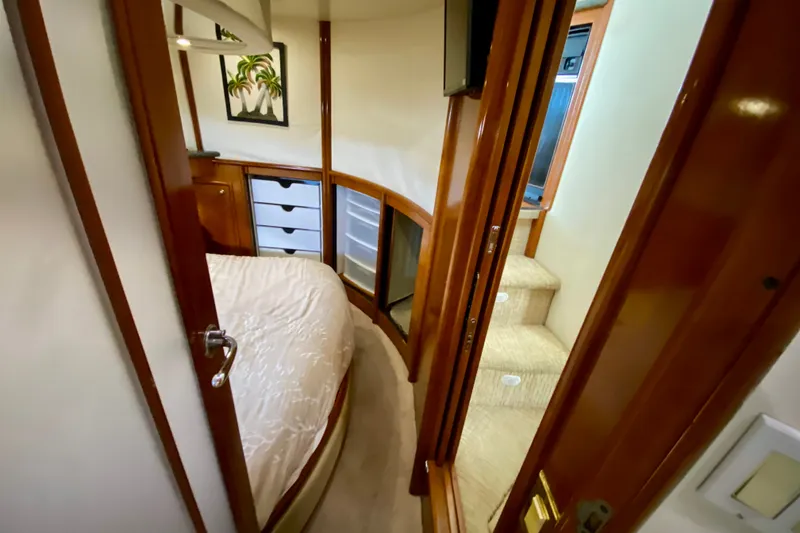 Slide: The Image of Interior of 2000 Carver 450 Voyager Pilothouse, featuring cozy bedroom and wooden cabinetry. - 51