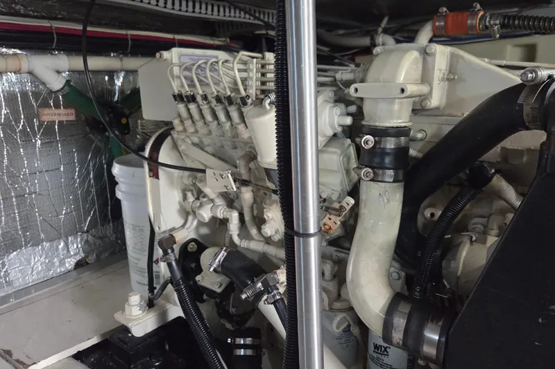 Slide: The Image of Engine room of a 2000 Carver 450 Voyager Pilothouse yacht, showcasing mechanical components. - 92
