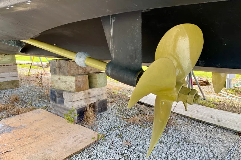 Slide: The Image of Propeller of 2000 Carver 450 Voyager Pilothouse on dry dock, supported by wooden blocks. - 18