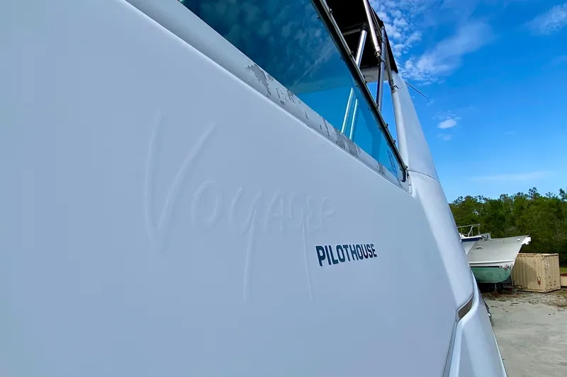 Slide: The Image of 2000 Carver 450 Voyager Pilothouse yacht side view with clear blue sky. - 83