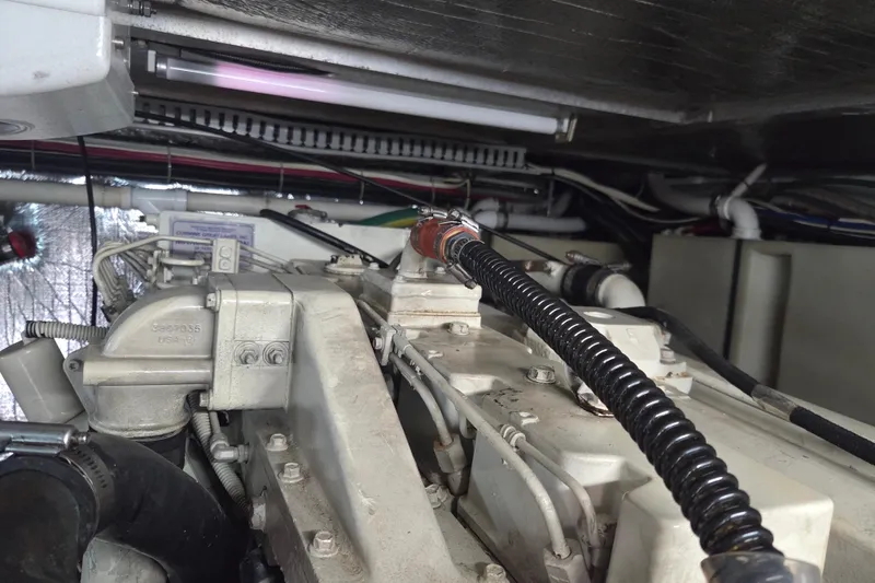 Slide: The Image of Engine room of 2000 Carver 450 Voyager Pilothouse with visible components and wiring. - 97