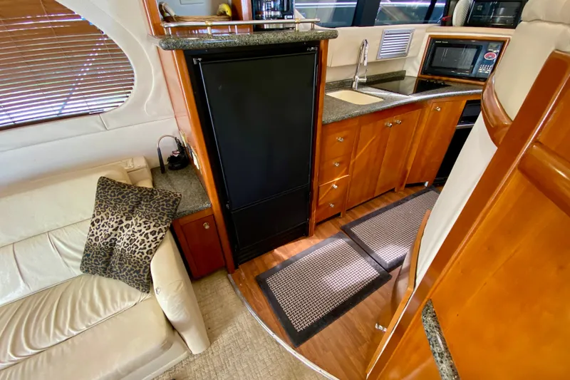 Slide: The Image of Interior of 2000 Carver 450 Voyager Pilothouse with kitchen and seating area. - 31