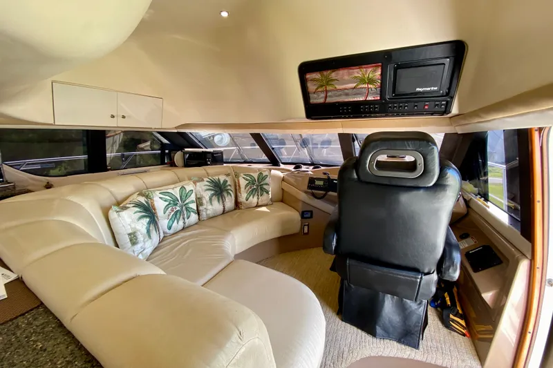 Slide: The Image of Luxurious interior of 2000 Carver 450 Voyager Pilothouse with plush seating and palm-themed decor. - 64