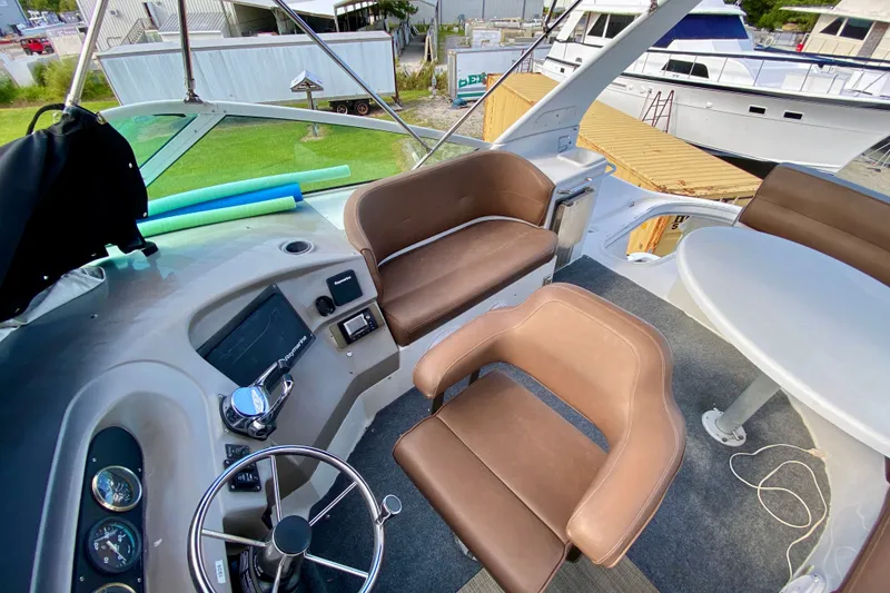 Slide: The Image of Interior view of 2000 Carver 450 Voyager Pilothouse with helm and seating area. - 97
