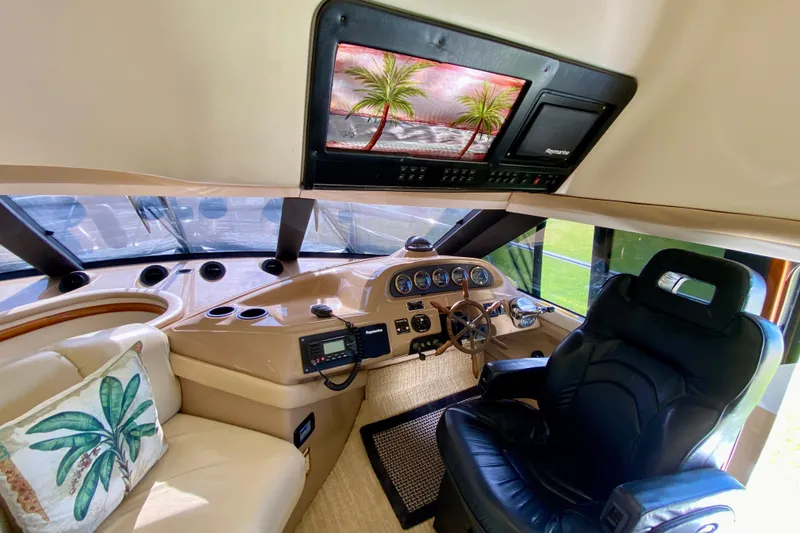 Slide: The Image of Interior of 2000 Carver 450 Voyager Pilothouse with helm, leather seating, and navigation equipment. - 66