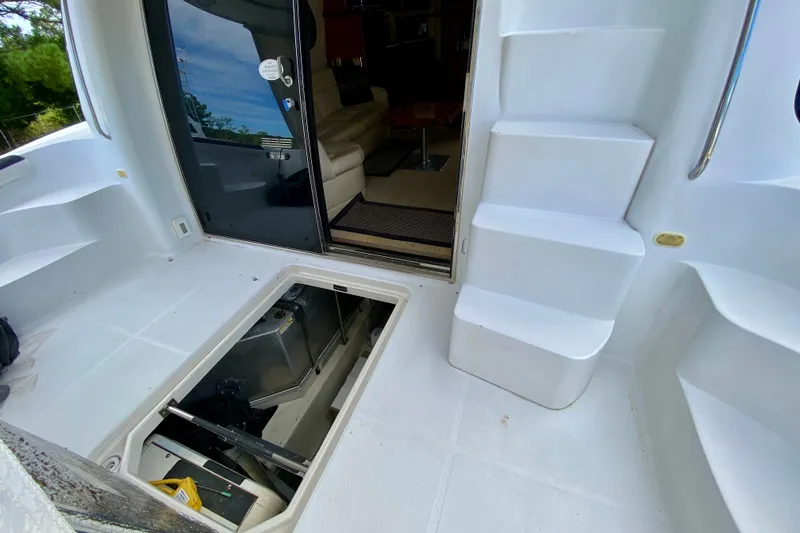 Slide: The Image of 2000 Carver 450 Voyager Pilothouse yacht interior with open hatch and steps. - 23