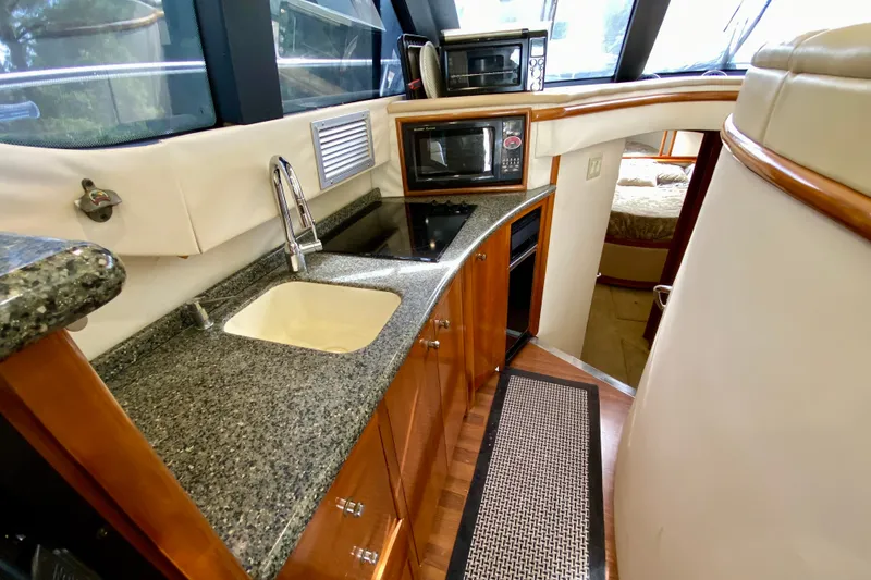 Slide: The Image of Luxurious kitchen area in a 2000 Carver 450 Voyager Pilothouse yacht, featuring modern appliances. - 32