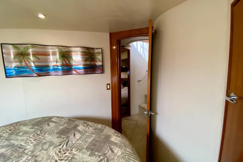Slide: The Image of Interior of 2000 Carver 450 Voyager Pilothouse with tropical artwork and cozy bedroom. - 37