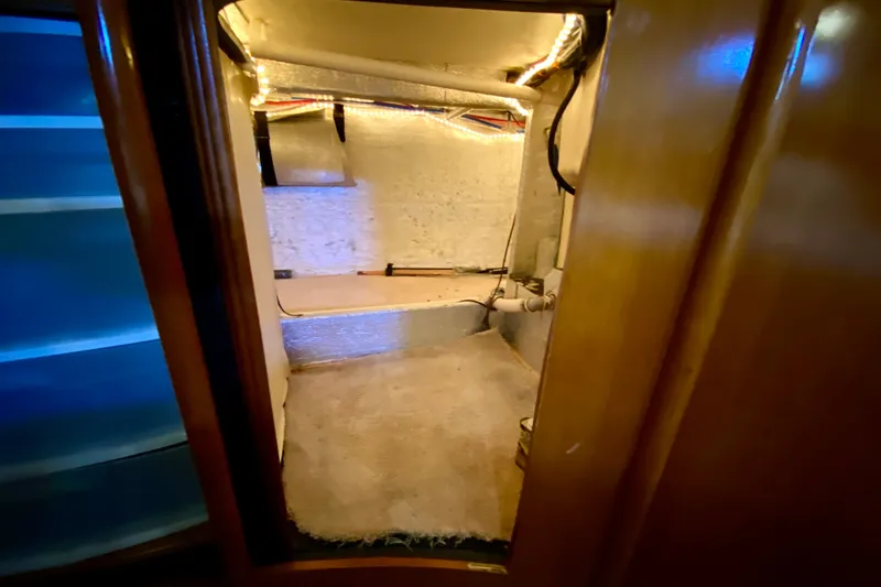 Slide: The Image of Interior view of a 2000 Carver 450 Voyager Pilothouse, showcasing a storage or utility area. - 45