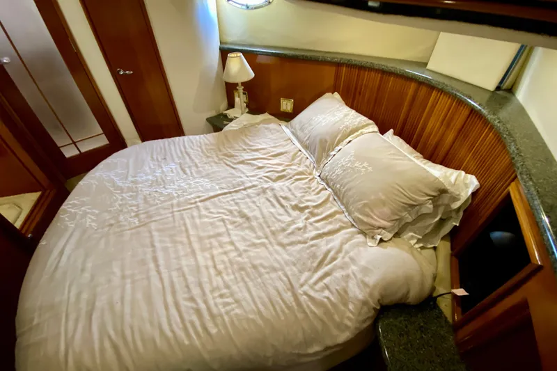 Slide: The Image of Luxurious bedroom interior of 2000 Carver 450 Voyager Pilothouse yacht with cozy bedding. - 43