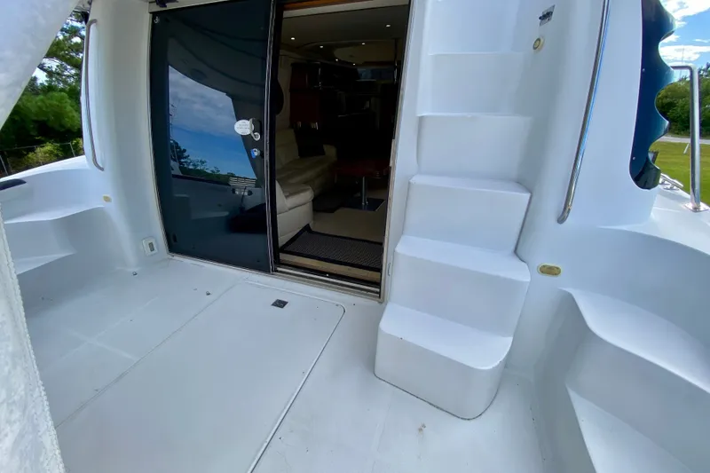 Slide: The Image of 2000 Carver 450 Voyager Pilothouse yacht interior view with steps and seating area. - 88