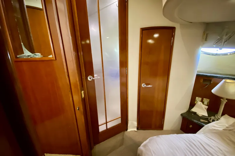 Slide: The Image of Interior of 2000 Carver 450 Voyager Pilothouse with wooden doors and cozy cabin features. - 47