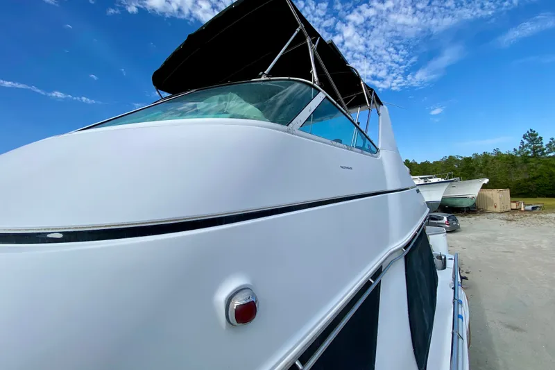 Slide: The Image of 2000 Carver 450 Voyager Pilothouse yacht with sleek design under a clear blue sky. - 82