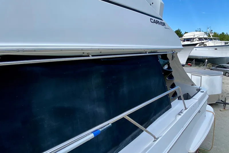 Slide: The Image of 2000 Carver 450 Voyager Pilothouse yacht side view in a marina setting. - 84