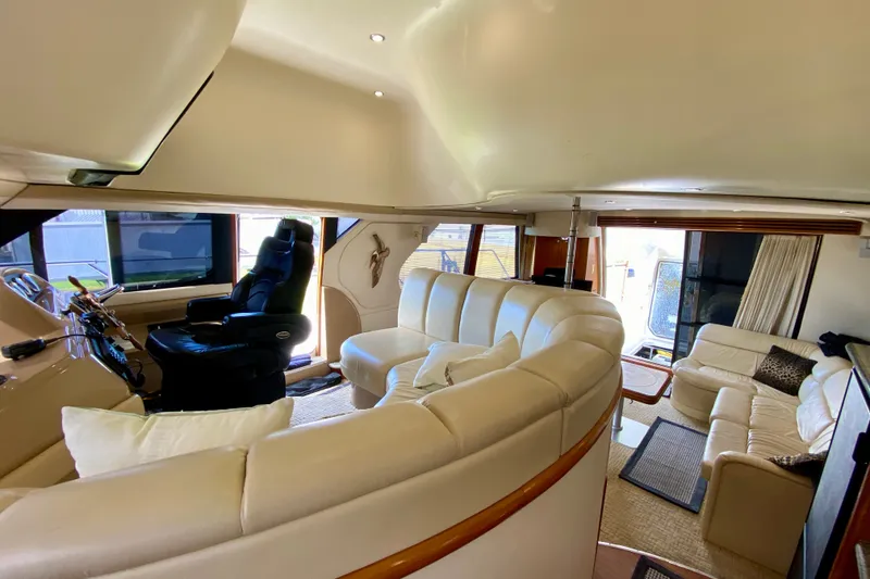 Slide: The Image of Luxurious interior of 2000 Carver 450 Voyager Pilothouse yacht with plush seating and helm. - 58