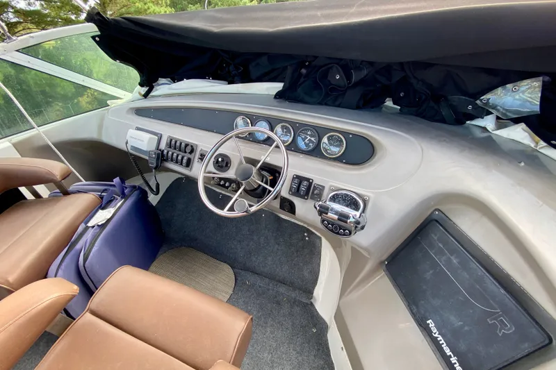 Slide: The Image of Interior view of 2000 Carver 450 Voyager Pilothouse helm with steering wheel and controls. - 95