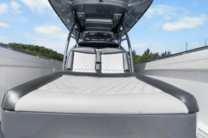 Slide: The Image of 2021 Nor-Tech 390 Sport Center Console boat interior with cushioned seating and sleek design. - 15