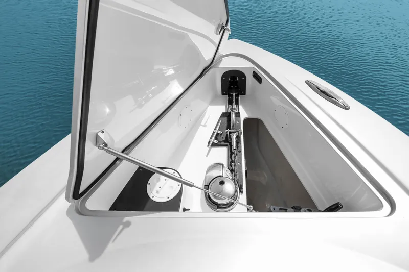 Slide: The Image of Open anchor compartment of 2021 Nor-Tech 390 Sport Center Console boat on water. - 16