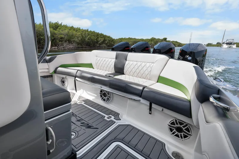 Slide: The Image of 2021 Nor-Tech 390 Sport Center Console boat interior with luxurious seating and powerful engines. - 21