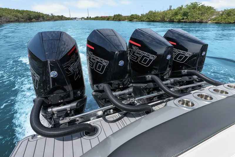 Slide: The Image of 2021 Nor-Tech 390 Sport Center Console with four powerful outboard engines on blue water. - 24
