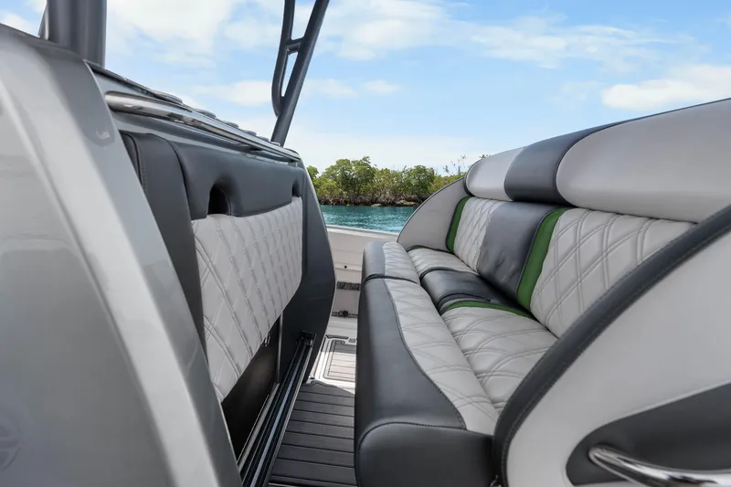 Slide: The Image of 2021 Nor-Tech 390 Sport Center Console interior with luxurious seating and scenic water view. - 26