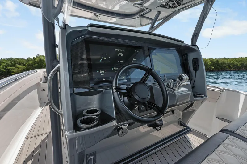 Slide: The Image of 2021 Nor-Tech 390 Sport Center Console helm with advanced navigation displays and controls. - 32