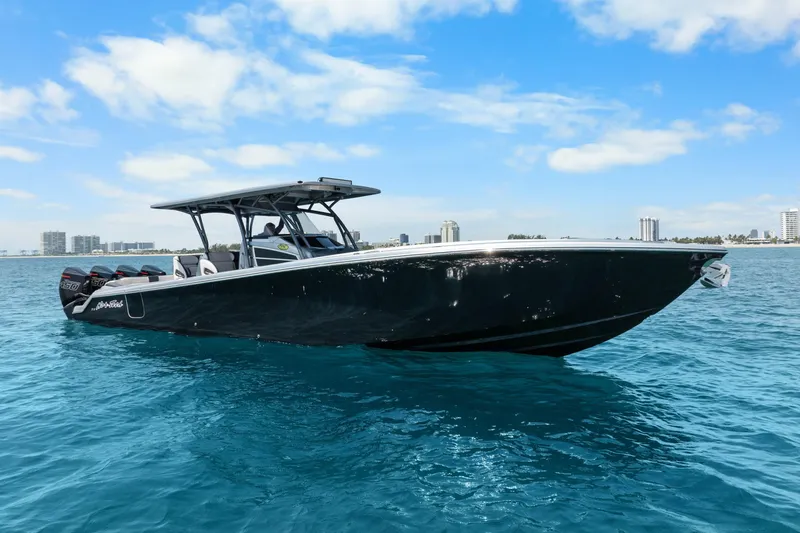 Slide: The Image of 2021 Nor-Tech 390 Sport Center Console boat cruising on clear blue water. - 36