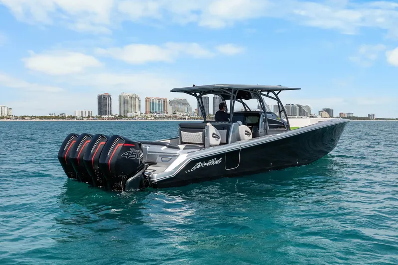 Slide: The Image of 2021 Nor-Tech 390 Sport Center Console boat on blue ocean near city skyline. - 38