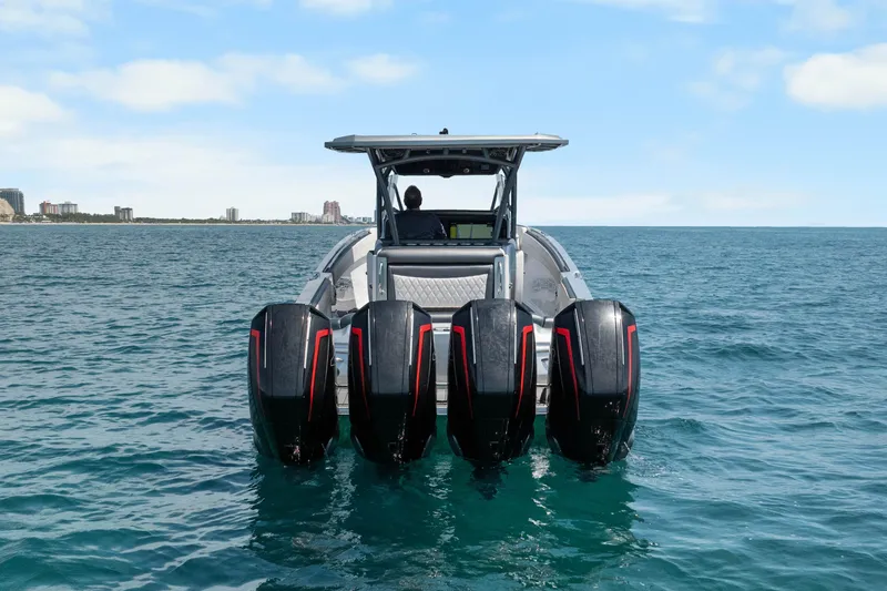 Slide: The Image of 2021 Nor-Tech 390 Sport Center Console boat with four engines on open water. - 39