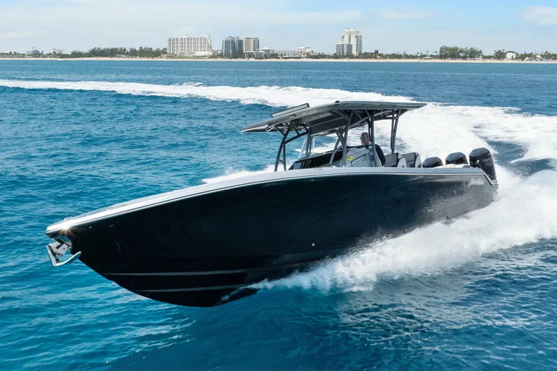 Slide: The Image of 2021 Nor-Tech 390 Sport Center Console cruising on blue ocean waters. - 4