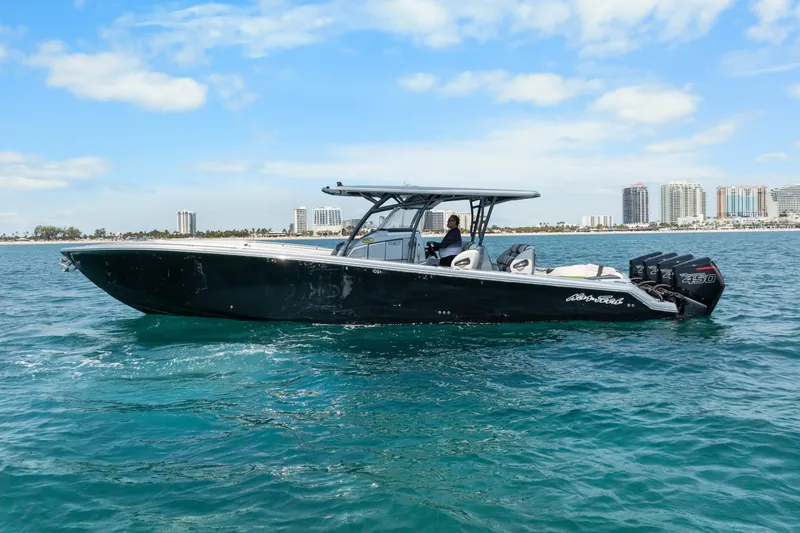Slide: The Image of 2021 Nor-Tech 390 Sport Center Console boat cruising on clear blue water. - 43