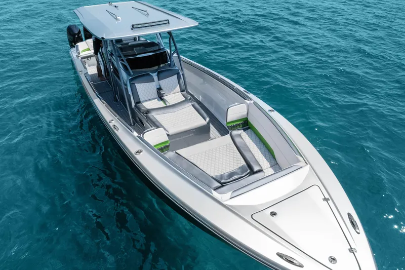 Slide: The Image of 2021 Nor-Tech 390 Sport Center Console boat on clear blue water. - 46