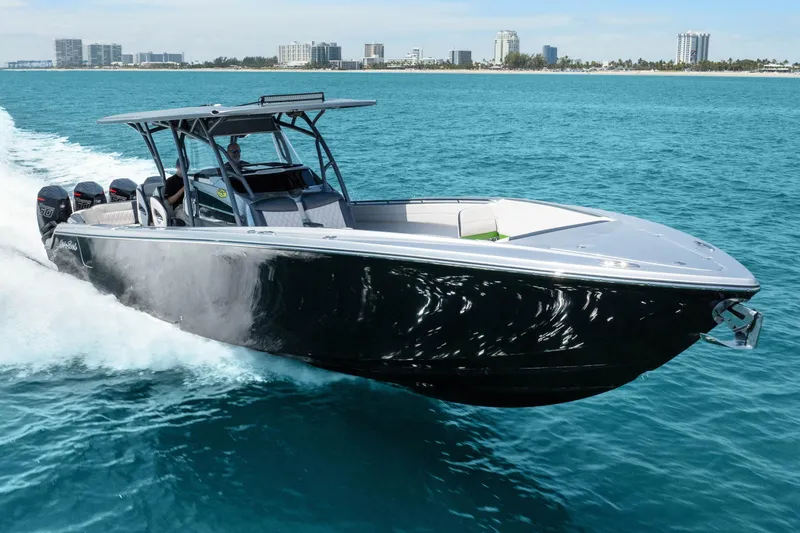Slide: The Image of 2021 Nor-Tech 390 Sport Center Console cruising on clear blue ocean waters. - 47