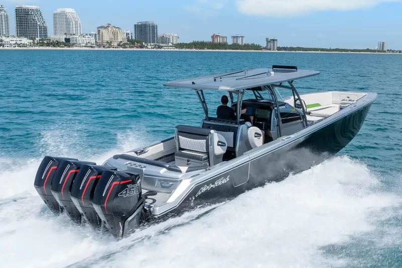 Slide: The Image of 2021 Nor-Tech 390 Sport Center Console cruising on ocean near city skyline. - 49