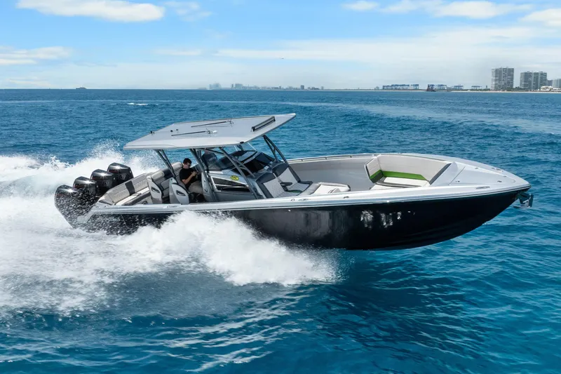 Slide: The Image of 2021 Nor-Tech 390 Sport Center Console cruising on open water, showcasing sleek design and power. - 5