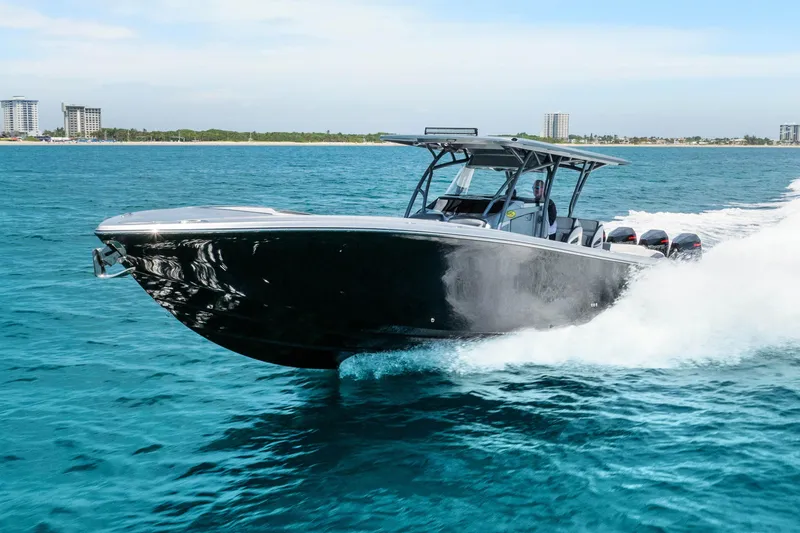 Slide: The Image of 2021 Nor-Tech 390 Sport Center Console cruising on blue ocean waters. - 51
