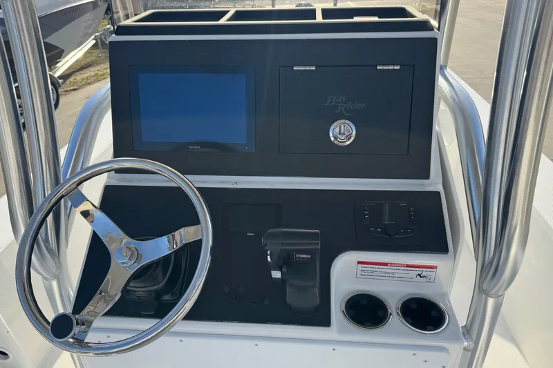 Slide: The Image of Bay Rider 2460 FS Skiff 2026 helm with steering wheel and display. - 14