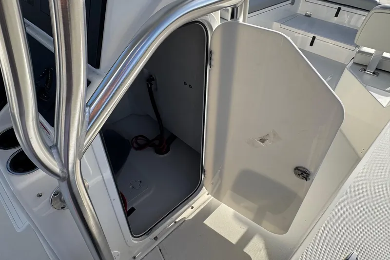 Slide: The Image of Open storage compartment door on a 2026 Bay Rider 2460 FS Skiff. - 9