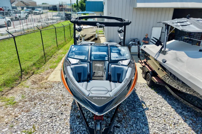 Slide: The Image of 2023 Malibu Wakesetter 23 LSV boat displayed outdoors, showcasing sleek design and modern features. - 26
