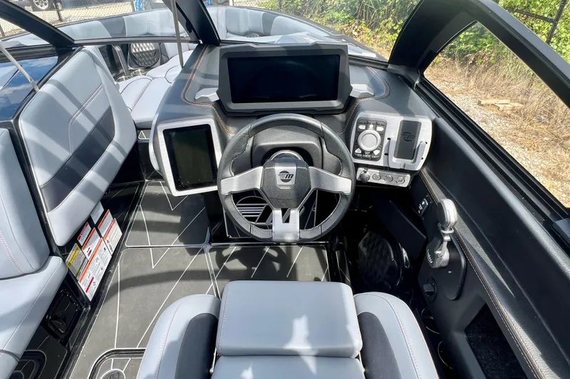 Slide: The Image of 2023 Malibu Wakesetter 23 LSV boat interior with modern dashboard and steering wheel. - 5