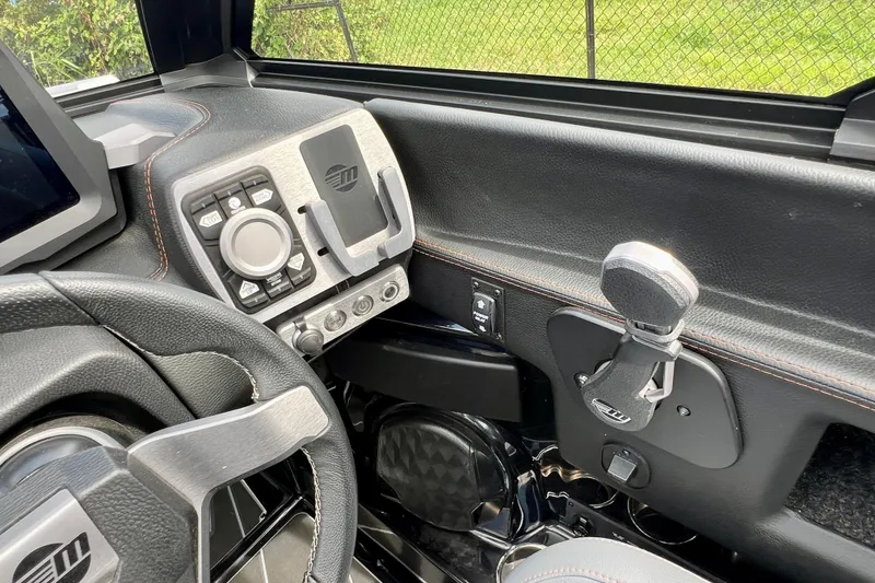 Slide: The Image of 2023 Malibu Wakesetter 23 LSV dashboard with steering wheel and control panel. - 19