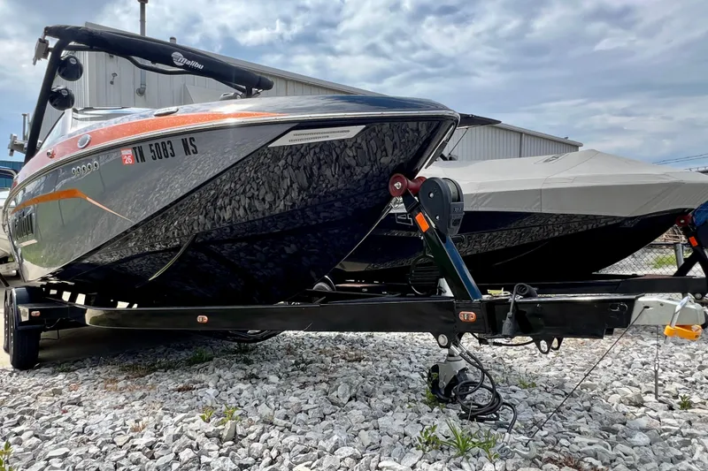 Slide: The Image of 2023 Malibu Wakesetter 23 LSV boat on trailer, parked outdoors on gravel. - 24