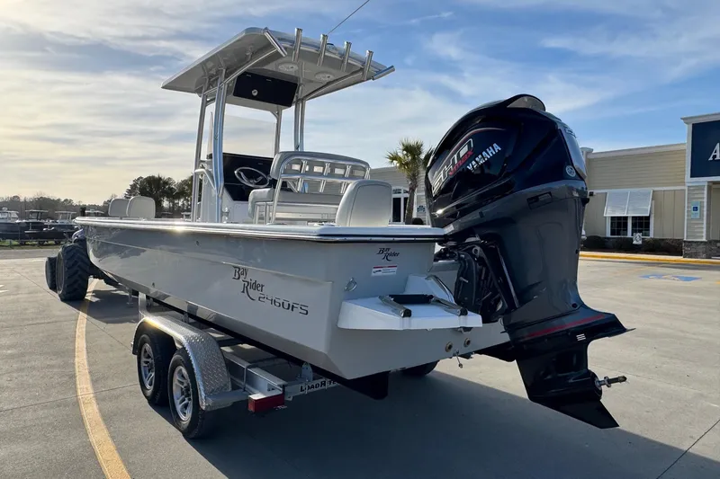 Slide: The Image of Bay Rider 2460 FS Skiff 2026 on trailer with Yamaha engine. - 2