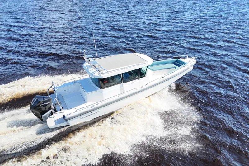 The Image of 2020 Axopar 28 CABIN boat cruising on open water, side view. - 0
