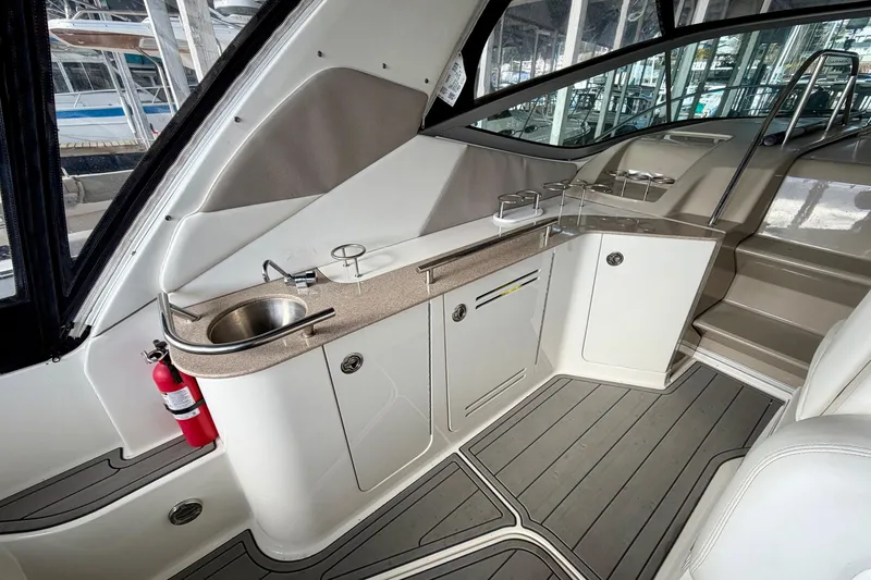 Slide: The Image of 2007 Sea Ray Sundancer 310 interior with kitchenette, sink, and fire extinguisher. - 11