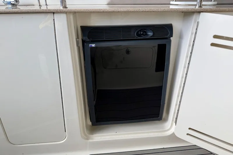 Slide: The Image of Compact refrigerator on 2007 Sea Ray Sundancer 310 yacht, integrated into white cabinetry. - 14