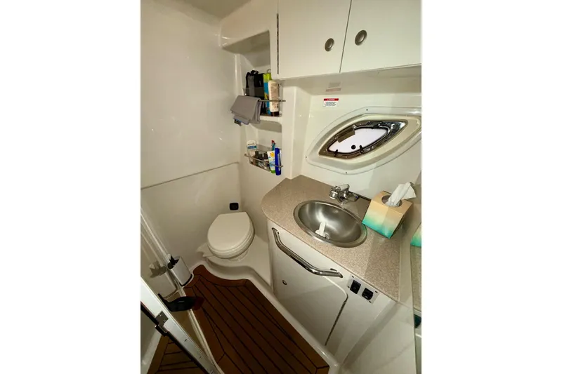 Slide: The Image of 2007 Sea Ray Sundancer 310 bathroom with sink, toilet, and storage cabinets. - 15