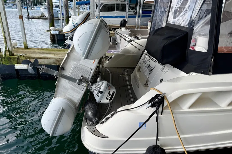 Slide: The Image of 2007 Sea Ray Sundancer 310 docked with inflatable boat and motor attached. - 2
